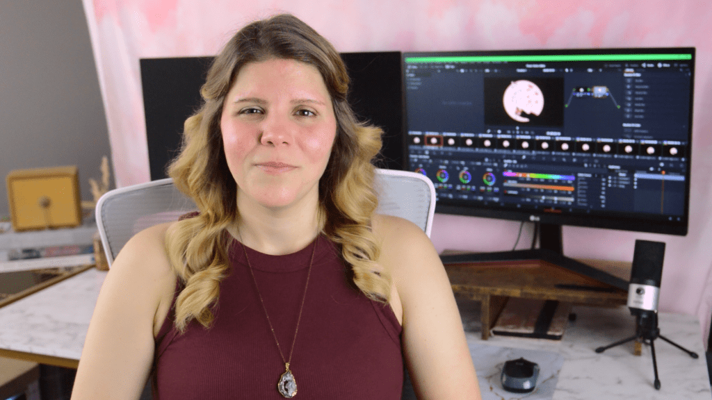 Alison Heidbreder smiling while sitting in front of her video editing station.